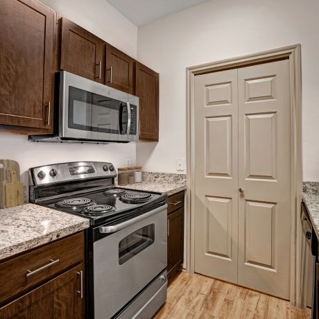 Elm Hollow apartment kitchen with stainless steel appliances and granite countertops